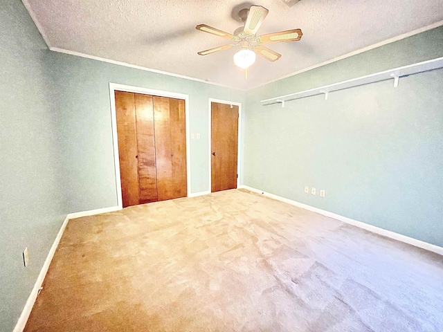 unfurnished bedroom with ornamental molding, carpet floors, and a textured ceiling