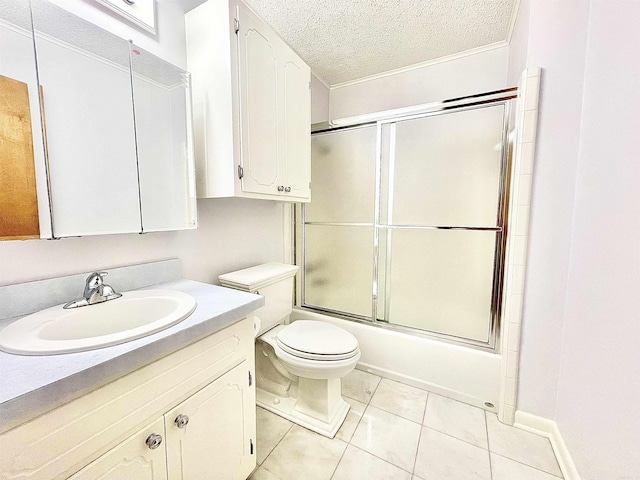 full bathroom featuring a textured ceiling, toilet, bath / shower combo with glass door, vanity, and tile patterned floors