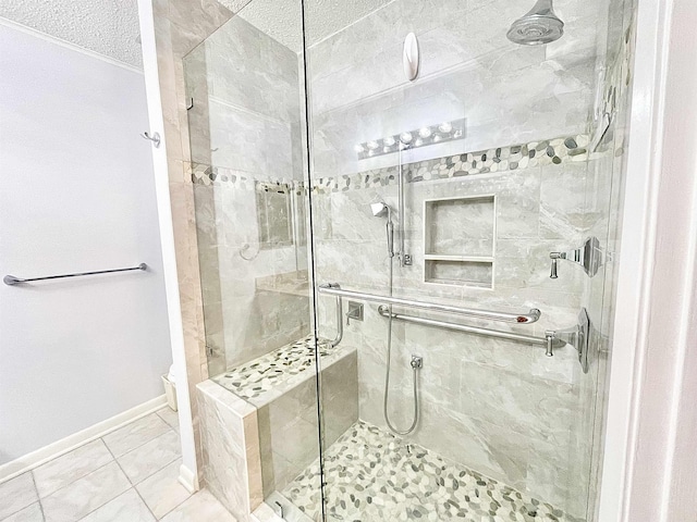 bathroom featuring a stall shower, tile patterned floors, and baseboards