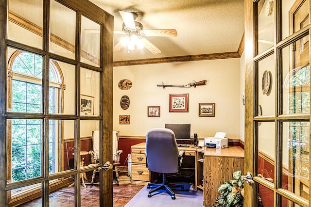 office with ornamental molding, a textured ceiling, ceiling fan, dark hardwood / wood-style floors, and french doors