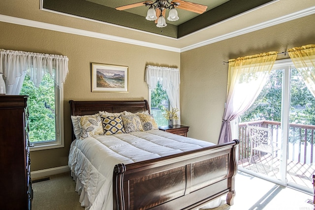 bedroom with multiple windows, ceiling fan, crown molding, and access to outside