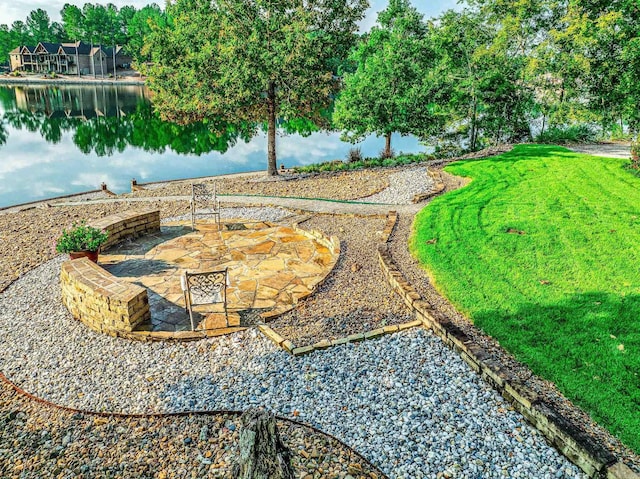 view of yard with a water view and a patio area