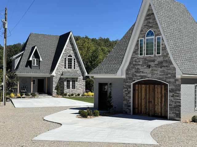 51 Yosemite Dr, Cherokee Village, AR 72529 - view of front of home with stone siding, driveway, roof with shingles, and a garage
