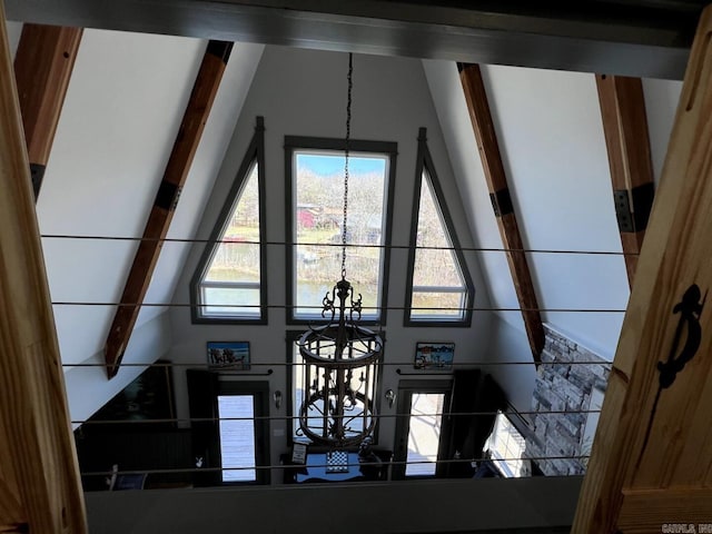 details featuring an inviting chandelier and beamed ceiling