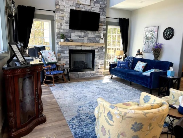 51 Yosemite Dr, Cherokee Village, AR 72529 - living area featuring healthy amount of natural light, wood finished floors, and a stone fireplace