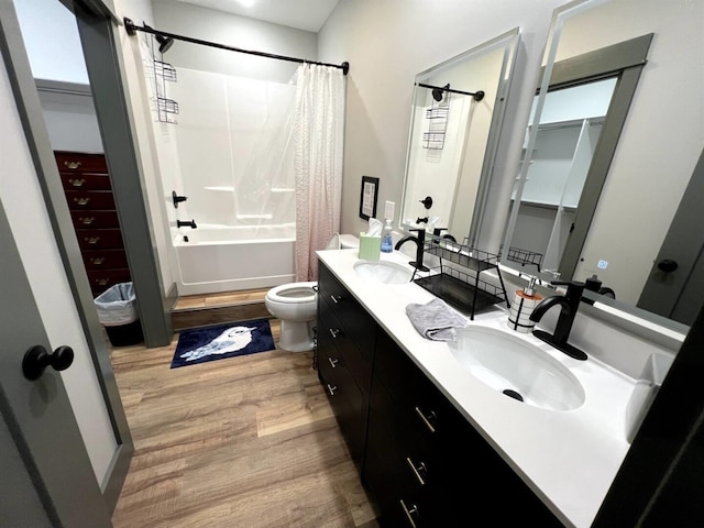 51 Yosemite Dr, Cherokee Village, AR 72529 - bathroom featuring wood finished floors, double vanity, shower / bath combo with shower curtain, and toilet