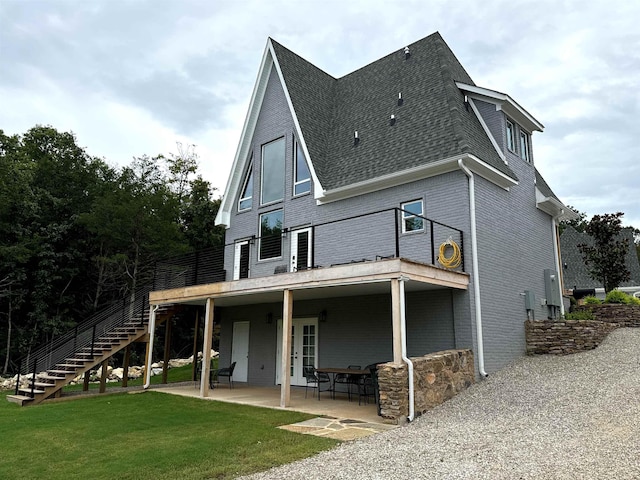 51 Yosemite Dr, Cherokee Village, AR 72529 - rear view of house featuring stairway, a shingled roof, a lawn, and a patio area