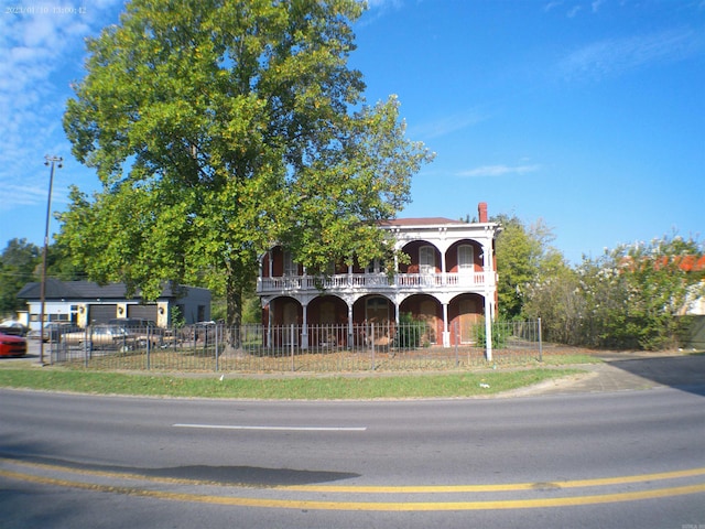 view of front of home featuring a balcony