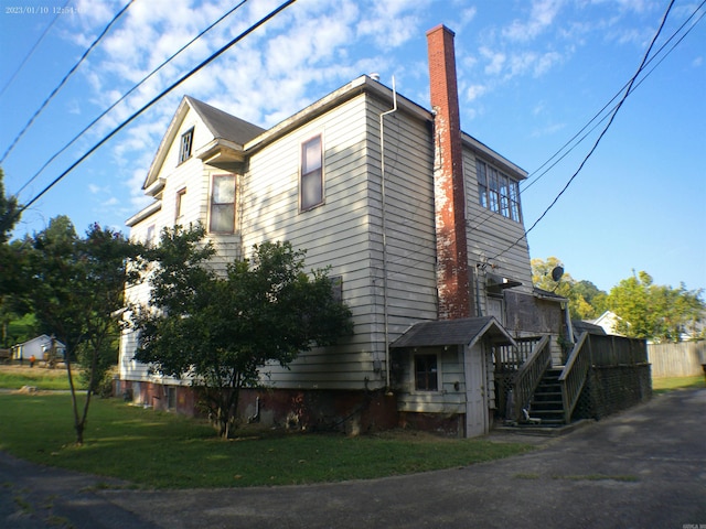 view of property exterior with a lawn