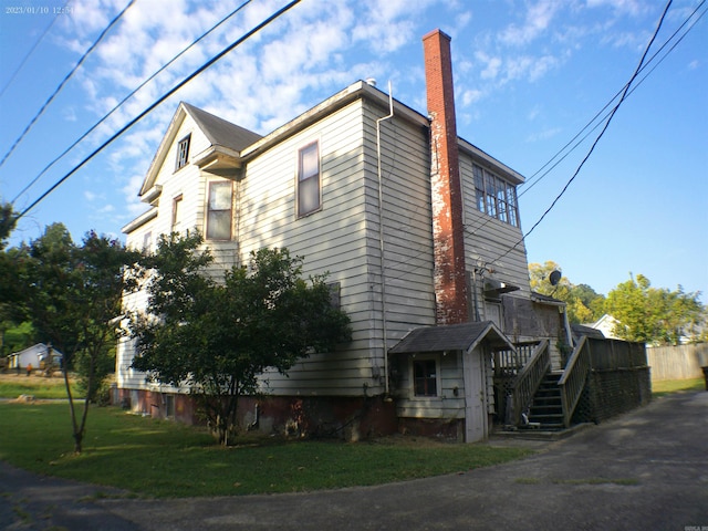 view of property exterior featuring a lawn