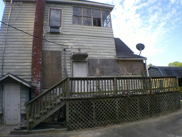 rear view of house featuring a deck