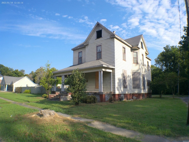 view of side of home with a lawn