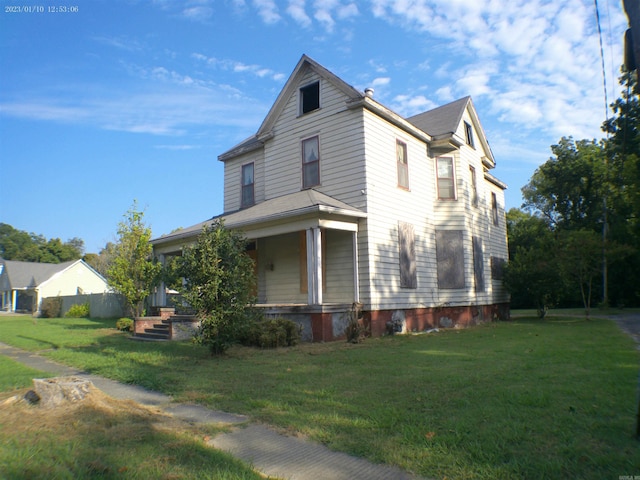 view of home's exterior featuring covered porch and a lawn