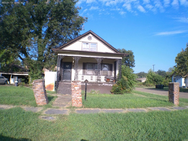 view of front of home featuring a front lawn and a porch