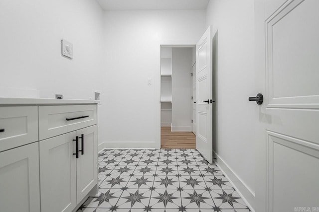 washroom with light hardwood / wood-style floors and cabinets