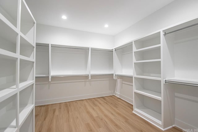 spacious closet with light hardwood / wood-style floors