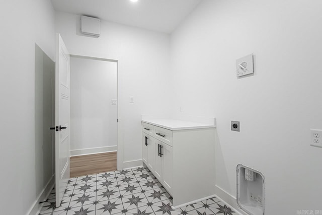 clothes washing area featuring light hardwood / wood-style flooring and electric dryer hookup