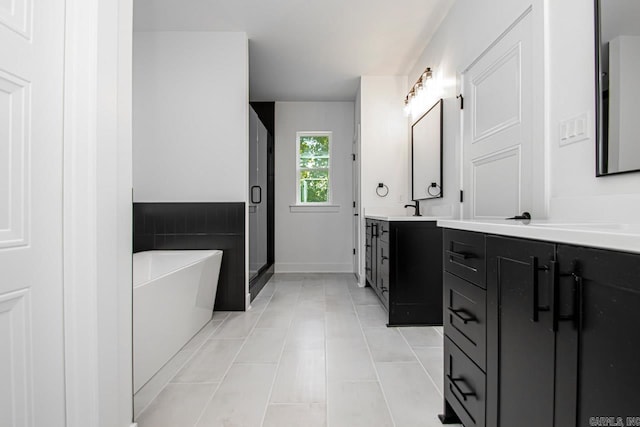 bathroom featuring tile patterned flooring, shower with separate bathtub, and vanity