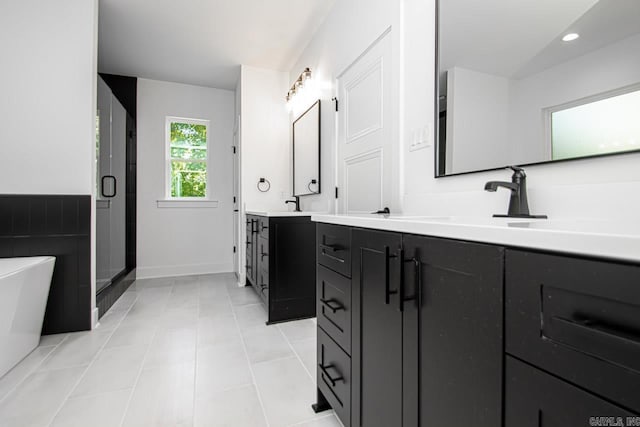 bathroom featuring tile patterned flooring, shower with separate bathtub, and vanity