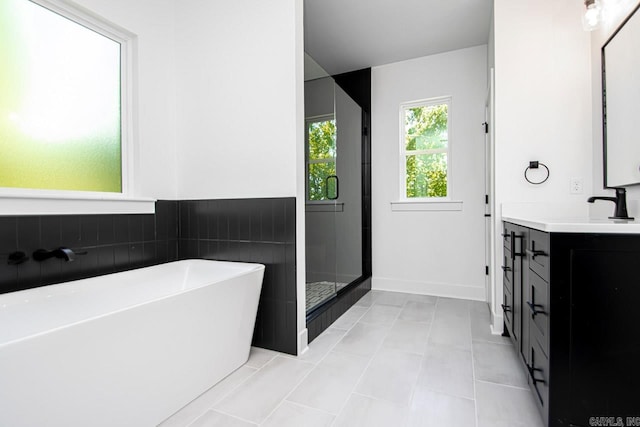 bathroom featuring vanity, separate shower and tub, and tile patterned floors