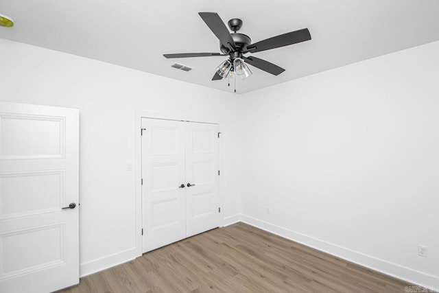 unfurnished room with hardwood / wood-style floors and ceiling fan