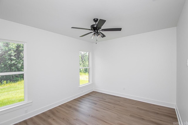 unfurnished room with hardwood / wood-style flooring and ceiling fan