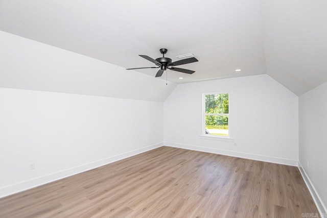 additional living space featuring vaulted ceiling, light hardwood / wood-style flooring, and ceiling fan