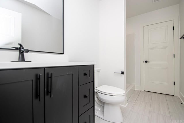 bathroom with toilet and vanity