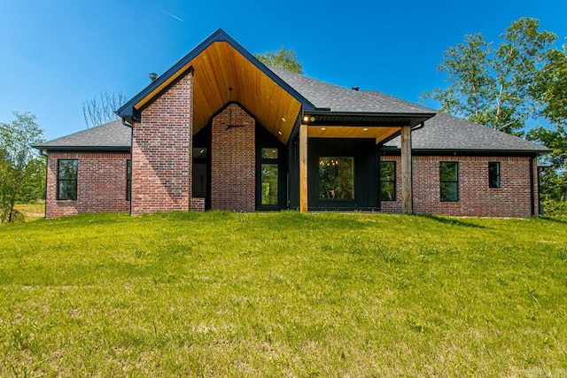 back of house with a lawn