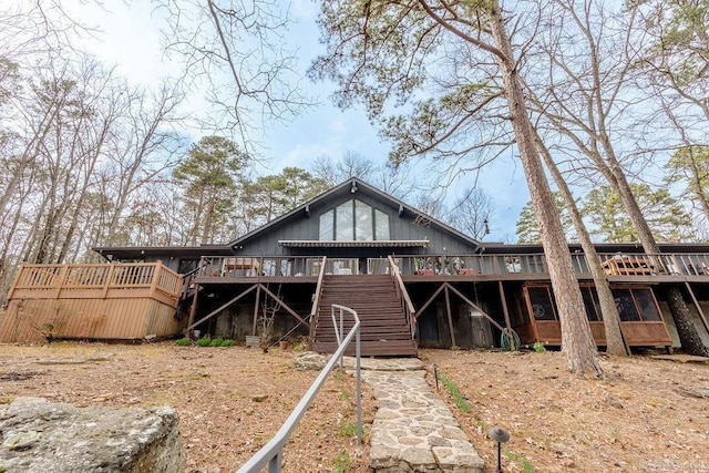 back of property with stairs and a deck