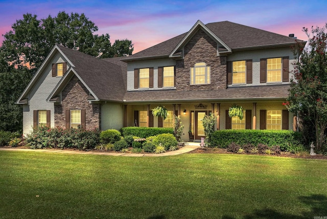 24 W Jericho Dr, Greenbrier, AR 72058 - view of front of property featuring stone siding, a shingled roof, a front yard, and brick siding