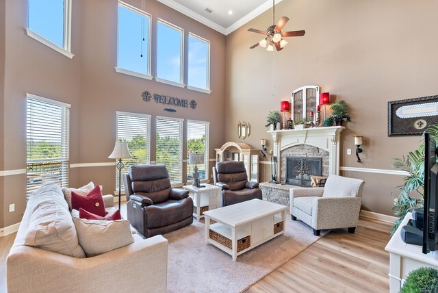 24 W Jericho Dr, Greenbrier, AR 72058 - living area featuring light wood-type flooring, a healthy amount of sunlight, a fireplace, and crown molding