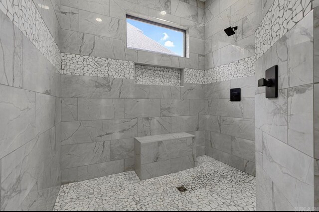 bathroom with a tile shower