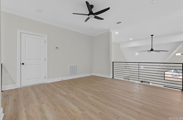 empty room featuring lofted ceiling, wood-type flooring, crown molding, and ceiling fan