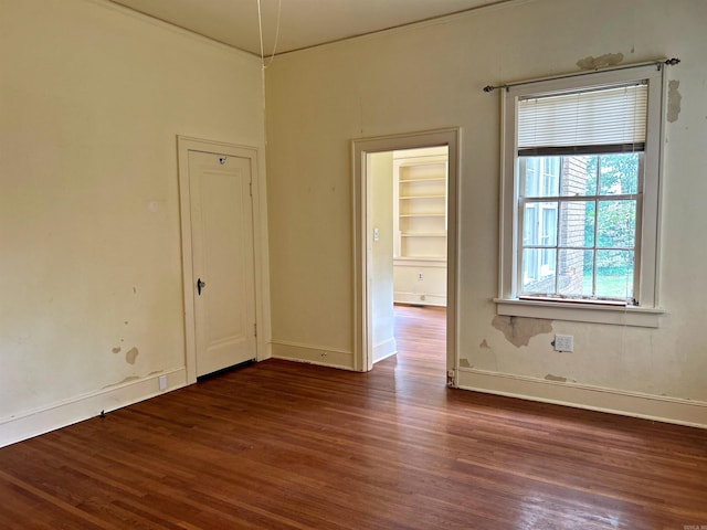 spare room with dark wood-type flooring