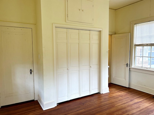 unfurnished bedroom with dark hardwood / wood-style floors