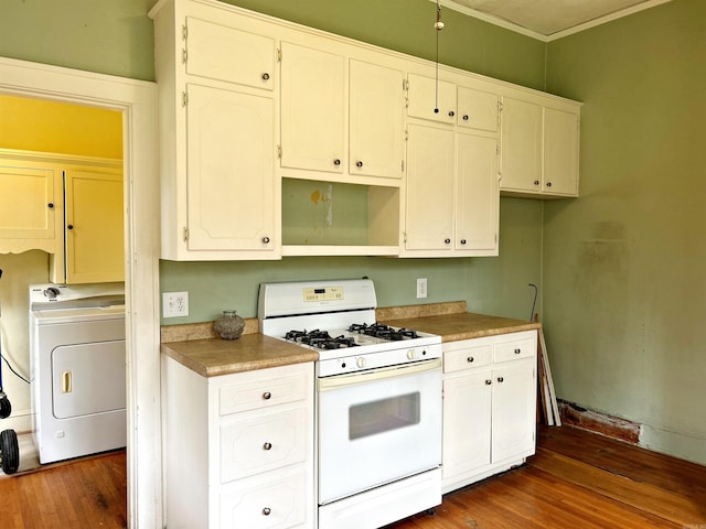 kitchen featuring dark hardwood / wood-style floors, white range with gas stovetop, white cabinets, and washer / clothes dryer