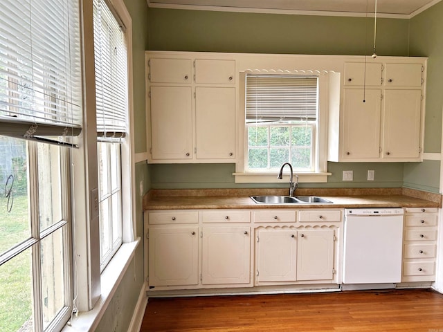 kitchen with white dishwasher, crown molding, sink, white cabinetry, and hardwood / wood-style flooring