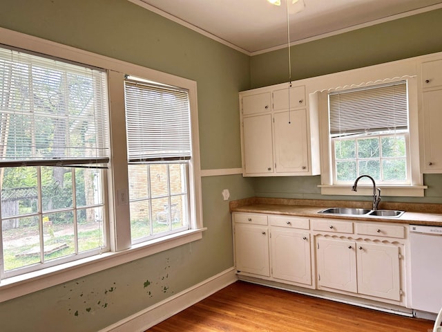 kitchen featuring white cabinetry, light hardwood / wood-style flooring, sink, and white dishwasher