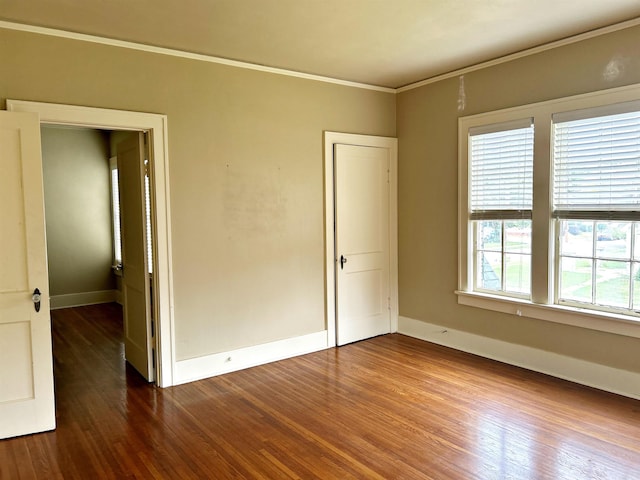 unfurnished bedroom with hardwood / wood-style floors and ornamental molding