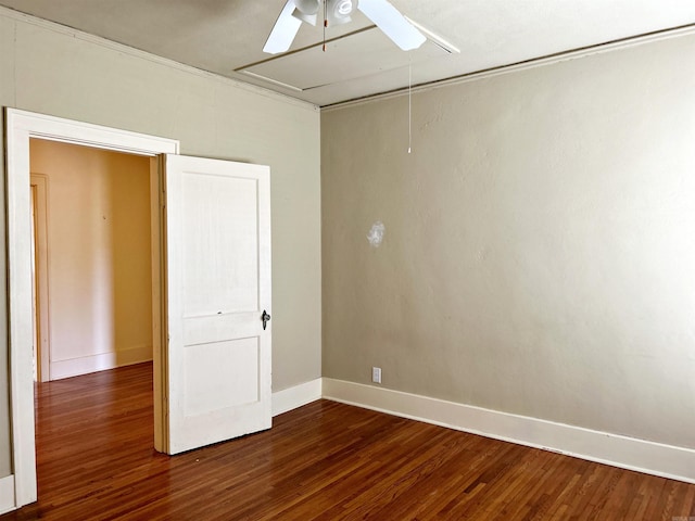 unfurnished bedroom featuring ceiling fan and dark hardwood / wood-style flooring