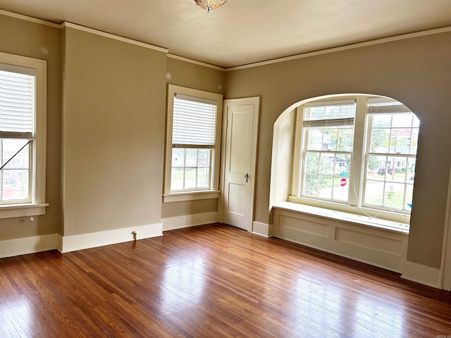 unfurnished room featuring ornamental molding and wood-type flooring