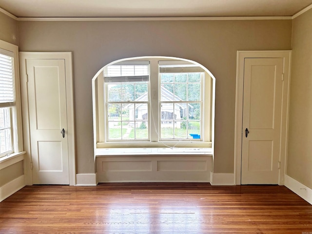 interior space with crown molding and hardwood / wood-style flooring