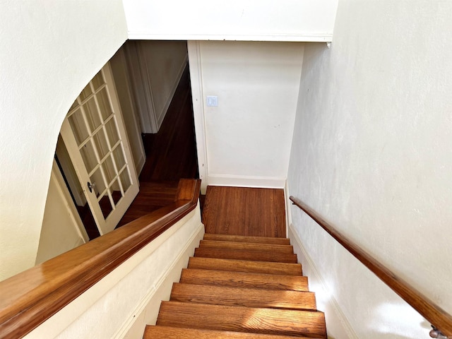 stairs featuring wood-type flooring