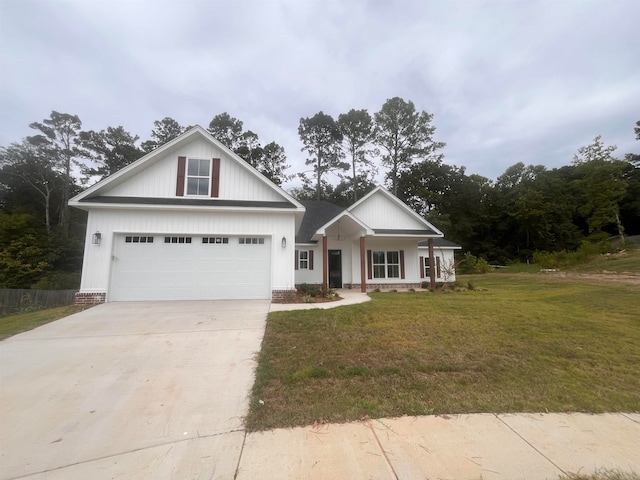 view of front of house featuring a front lawn, a garage, and a porch