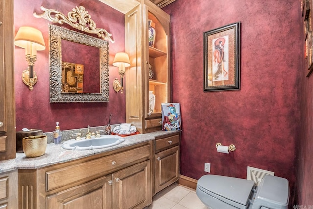 half bathroom featuring tile patterned flooring, toilet, visible vents, vanity, and baseboards