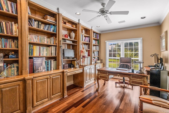 office space with ceiling fan, wood finished floors, visible vents, ornamental molding, and built in desk