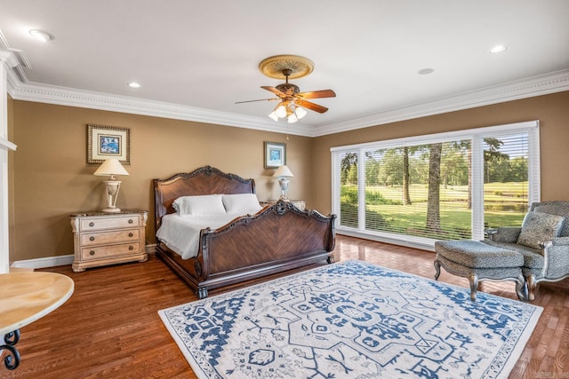 bedroom with ornamental molding, a ceiling fan, baseboards, and wood finished floors