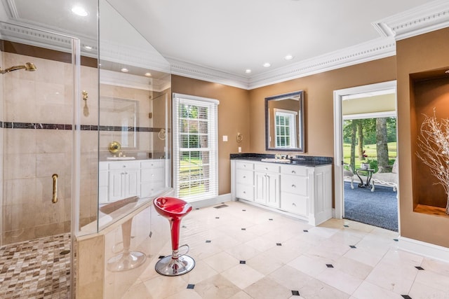 full bathroom with a stall shower, plenty of natural light, crown molding, and vanity