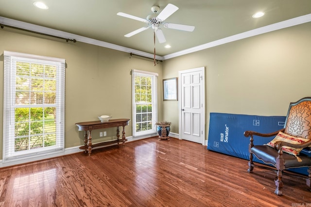 living area with recessed lighting, crown molding, baseboards, and wood finished floors